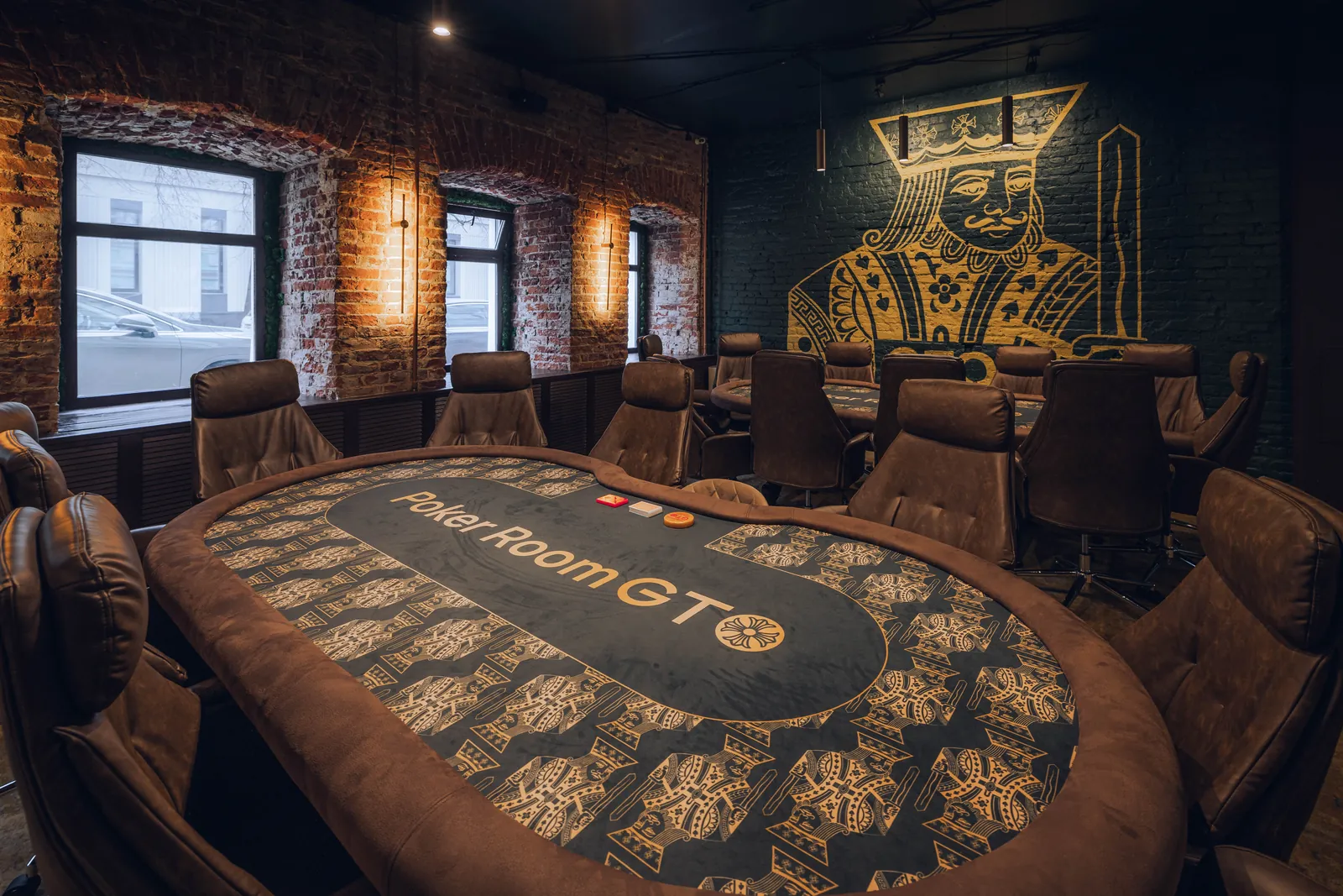 Poker table in warm light against brickwork